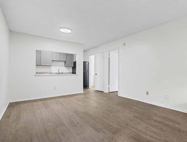 Empty living room with wood-style plank flooring at Oak Hollow